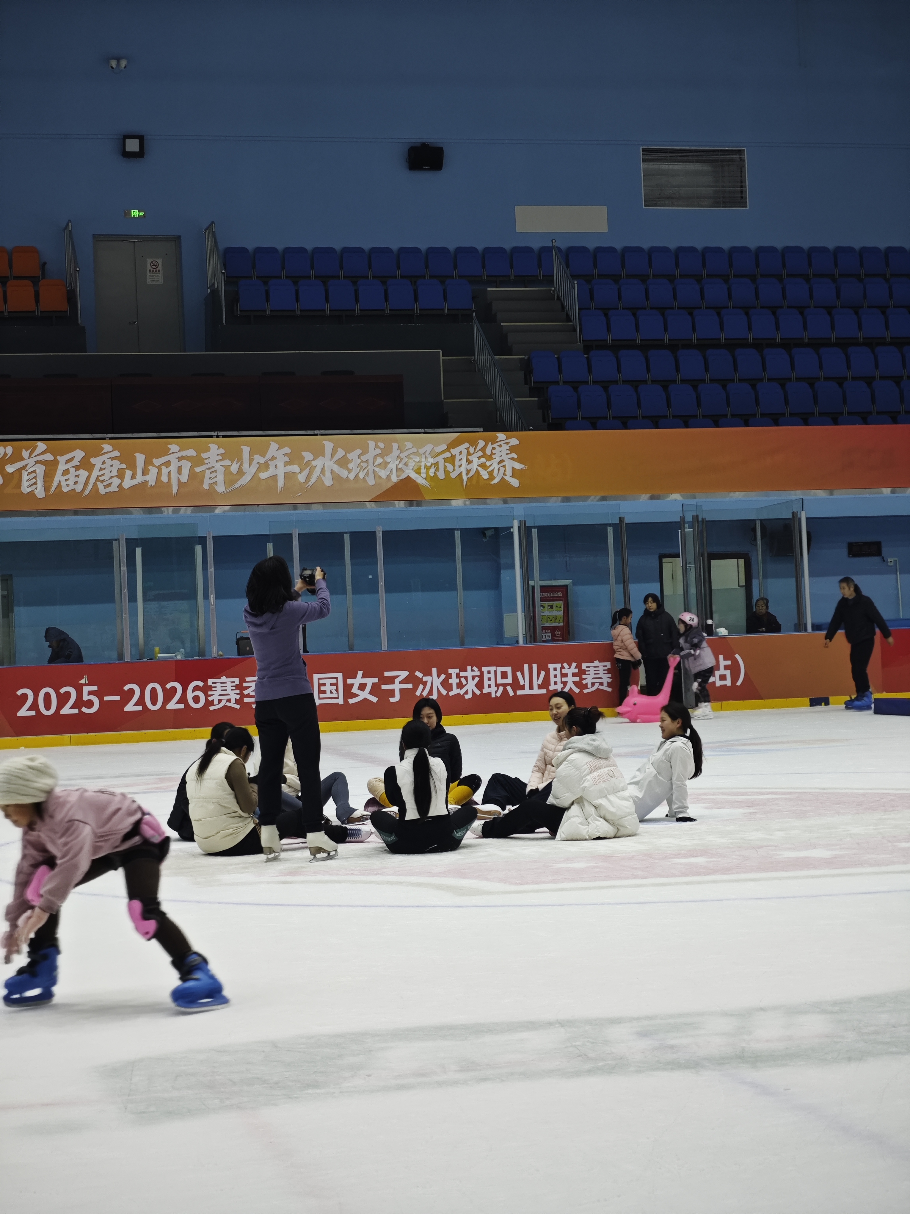 Adult learners taking a break together beside the rink