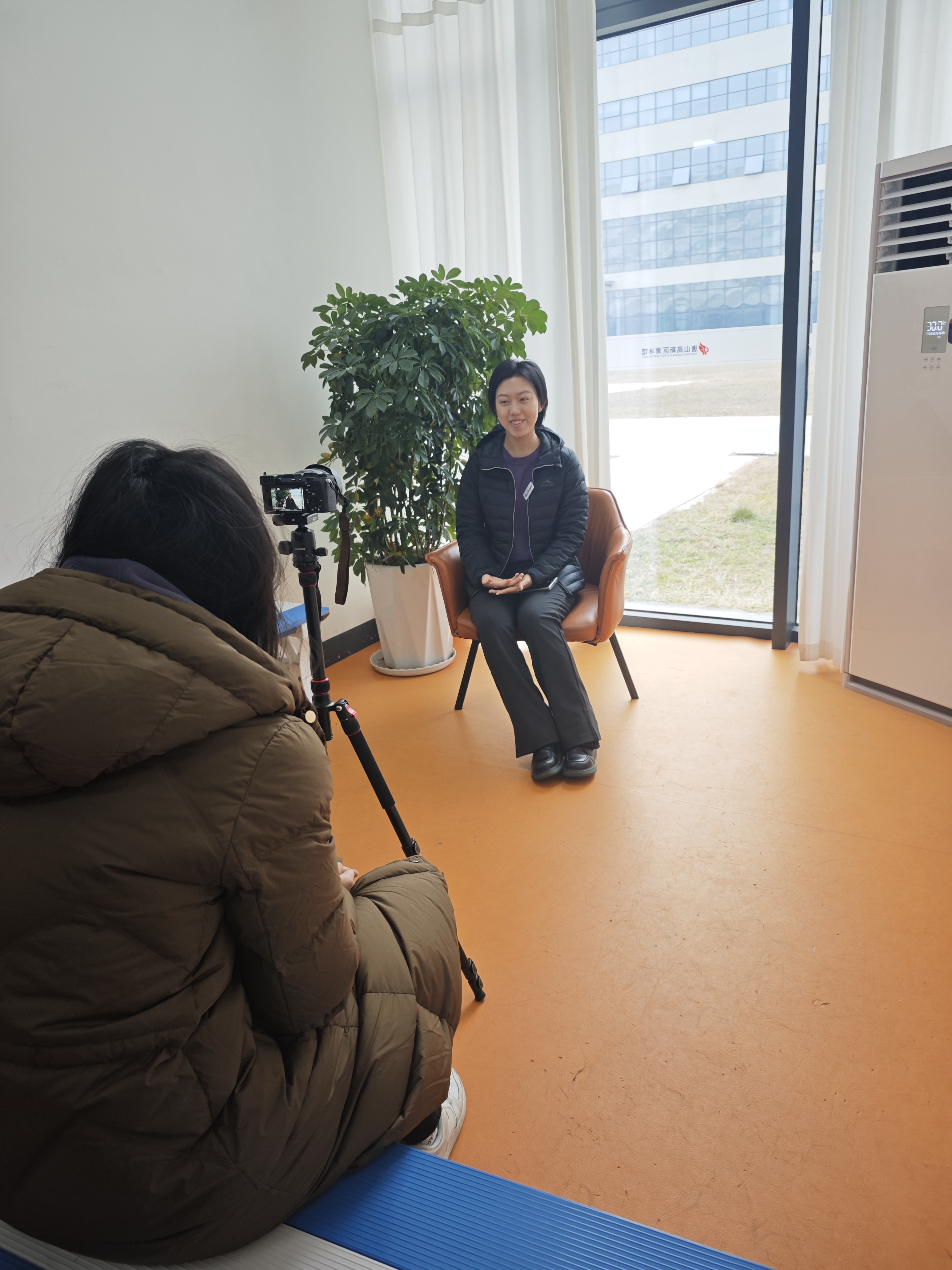 Xiping Sun speaking during a filmed interview